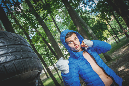 strong young boxer trains fists and handsの写真素材