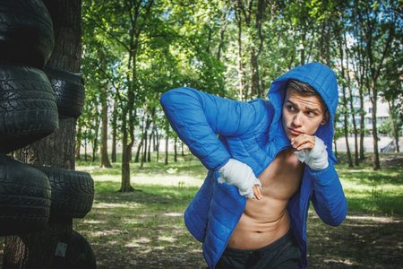 strong young boxer trains fists and handsの写真素材