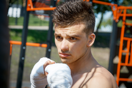 strong young boxer trains fists and handsの写真素材