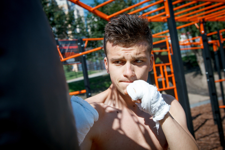 strong young boxer trains fists and handsの写真素材