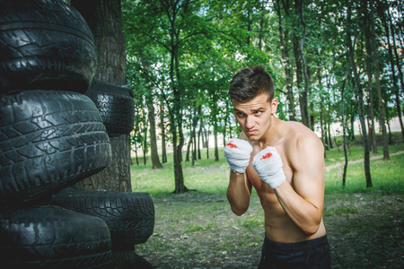 strong young boxer trains fists and handsの写真素材