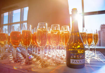 pink and white champagne glasses in the sun