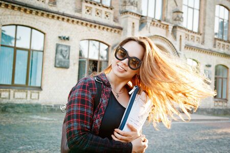 student near university building after writing an examの写真素材