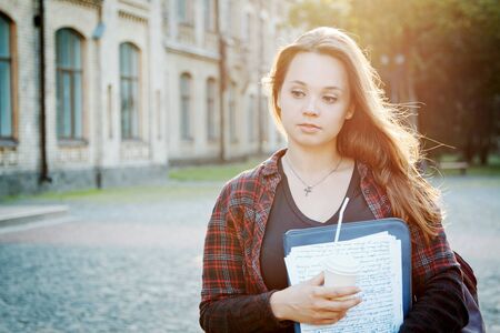 student near university building after writing an examの写真素材