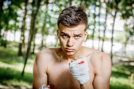 aggressive boxer diligently trains hands in blood