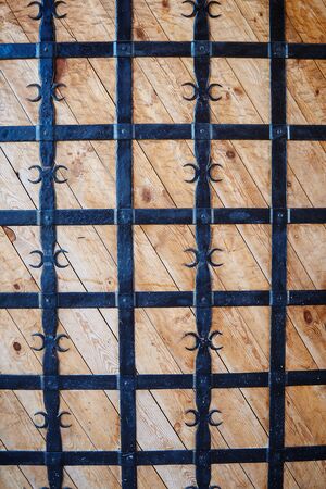 Wooden doors with black forged barsの写真素材