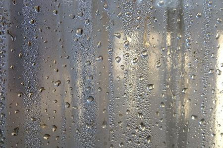 sweaty glass covered with small droplets of waterの写真素材