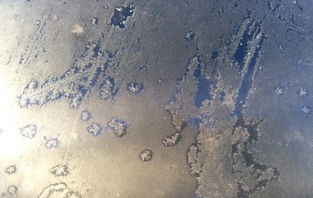 car glass covered with morning white frostの写真素材