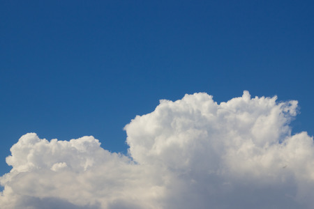 beautiful blue summer sky with white fluffy cloudsの写真素材