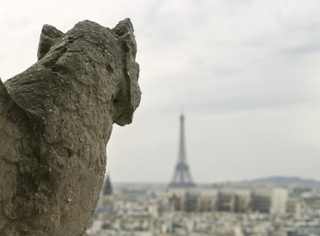 Gargoyle from backwards looking at the Eiffel Towerの写真素材