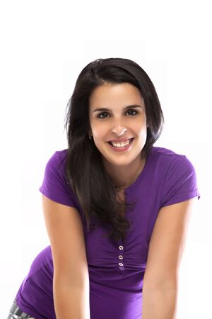 Young woman smiling with a violet t-shirt isolated on whiteの写真素材