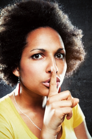 Afro Girl Asking for Silence making a hand sign as an indication to shut upの写真素材