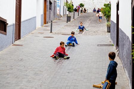 ICOD DE LOS VINOS, SPAIN - NOVEMBER 18  Childrens playing con wooden planks in the streets of Icod de los Vinos on November 18, 2012  Tradition feature in honor of San Andres of the municipalities of Icod and The Guancha on the island of Tenerife  Canary のeditorial素材
