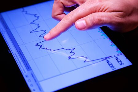 Closeup shot of a Hand Touching a Stock Echange Chartの写真素材