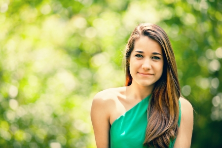 Beautiful Teenager Smiling in a Green Nataure Backgroundの写真素材