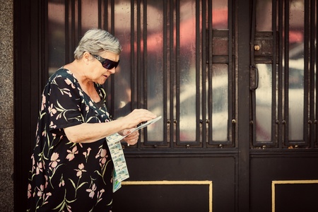 MADRID, SPAIN - AUGUST 12: Senior Woman Selling ONCE Lottery Coupons in the Streets of Madrid. ONCE...