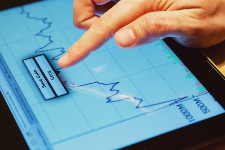 Man Analyzing Financial Data on a Tablet Screenの写真素材