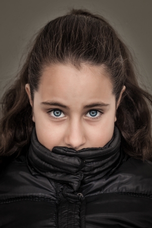 Serious Girl with Her Mouth Coveredの写真素材