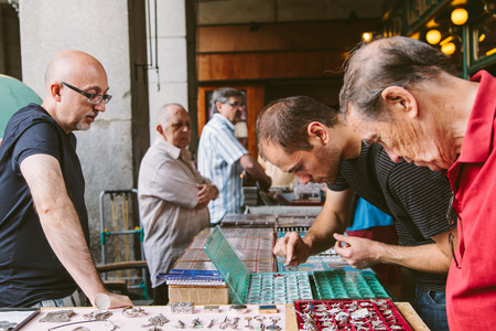 MADRID, SPAIN - SEPTEMBER 7: People at the Collectible Market of Stamps and Coins in Plaza Mayor, one of the most traditional Madrid classics on September 7, 2012 in Madrid.のeditorial素材