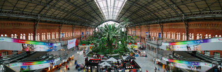 MADRID, SPAIN - SEPTEMBER 7: Panorama of the interior of 19th century Atocha Railway Station, the largest and primary station serving commuter, intercity and regional trains, on September 7, 2014 in Madrid, Spainのeditorial素材
