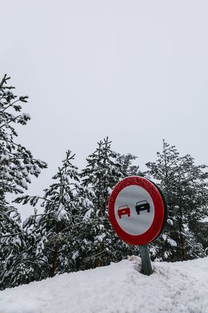 No Overtaking Sign in a Snowy Roadの写真素材