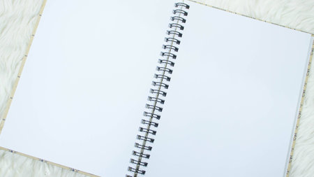Notebook on white wool topの写真素材