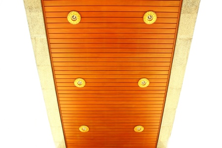 External wooden ceiling with lighting fixturesat Thai pagodaの写真素材