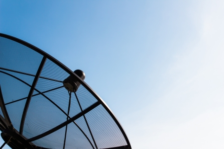Old single satellite dish with twilight blue sky backgroundの写真素材