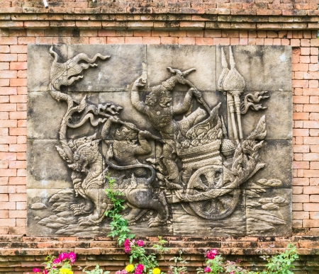Sculpture of Ramayana on wall in tropical Thai gardenの写真素材