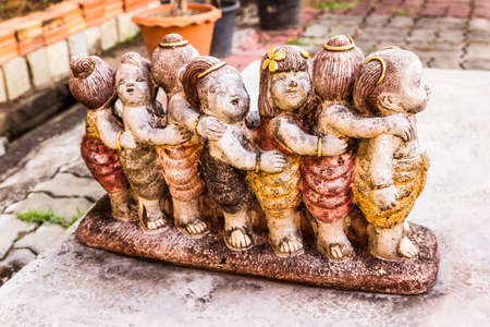 Very old sculpture of Thai children at kindergarten school, Thailandの写真素材