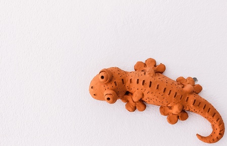 Creation idea, sculpture of gecko on rest room wallの写真素材