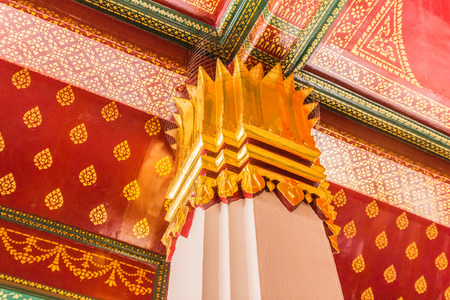 Columns decorated with gold plated ornament in Buddhist temple, Thailand