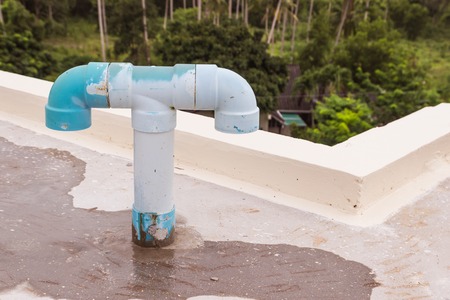 Old PVC air vent pipes on roof top of building