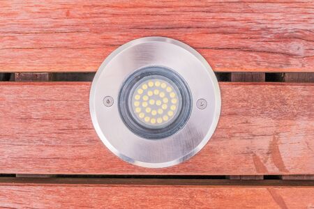 Construction details : closed up view of LED uplight installed on wooden deckのeditorial素材