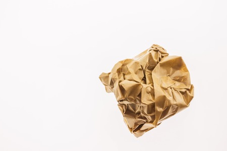 Crumpled brown paper isolated on white backgroundの写真素材