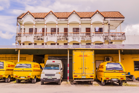 Phuket, Thailand - Dec 12, 2016: DHL courier pick-up cars parked at a DHL office shipment facility in Phuket, Thailandのeditorial素材