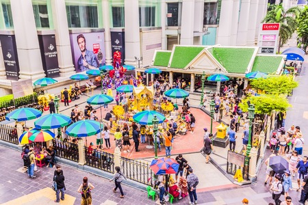 Bangkok, Thailand - July 11, 2017: People are paying respect to the Erawan Shrine, formally the Thao Maha Phrom Shrine, view from skywalk, at Grand Hyatt hotel corner, Ratchaprasong intersection, Bangkok, Thailand.のeditorial素材