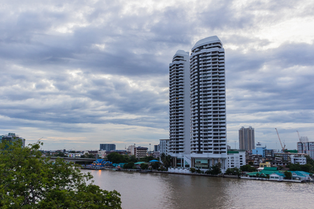 Bangkok, Thailand - July 8, 2017: High rise hotel building at the right-hand side of the "Chao Pra Ya" river against the twilight evening sky 
 backgroundのeditorial素材
