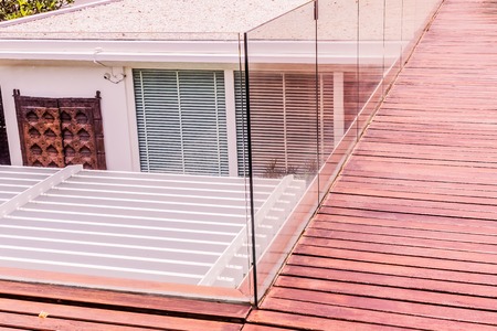 Construction details : Tempered glass balustrades on wooden roof deckの写真素材
