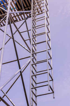 Steel ladder for climbing to the top of steel water tank tower in the rural area of Thailandの写真素材