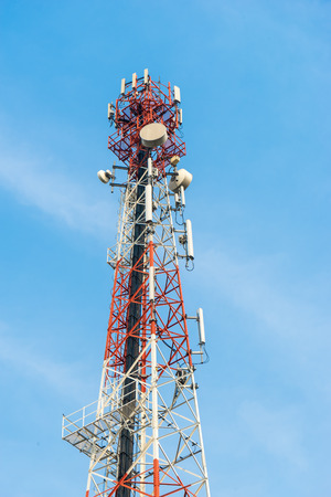 Mobile tower antennas with blue sky backgroundの写真素材