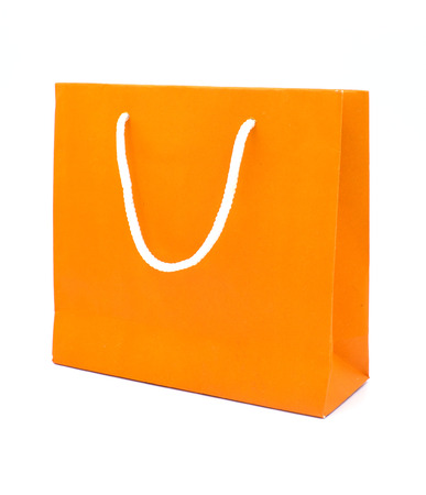 Orange paper bag isolated on white backgroundの写真素材