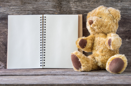 Open recipe book and Brown Bear on wooden backgroundの写真素材