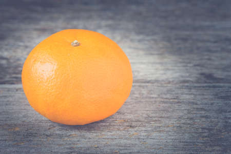 Orange fruit on wood background - Vintage filtered style.の写真素材