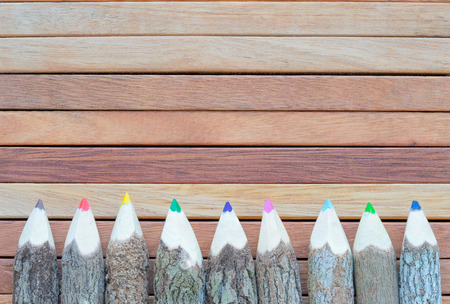 Colored pencils on the wooden background. Hand make color pencils.の写真素材