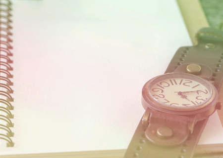 Empty top view of notebook on wooden background with retro style clock., filtered style,の写真素材