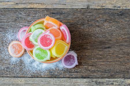 Jelly sweet, flavor fruit, candy dessert colorful in ceramic bowl on wood background.の写真素材