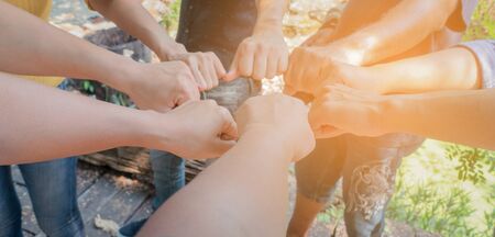 Business teamwork hands together joining group of people in circle with sun ray light and lens flare. - Concepts collaborate team and projects process to success.の写真素材