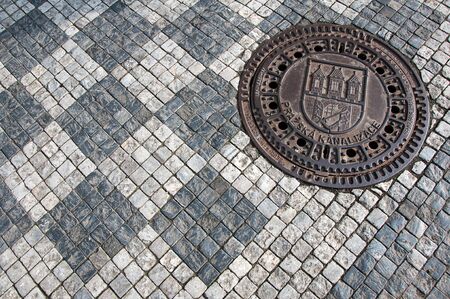 Sett and sewer manhole with Prague city coat of armsの写真素材