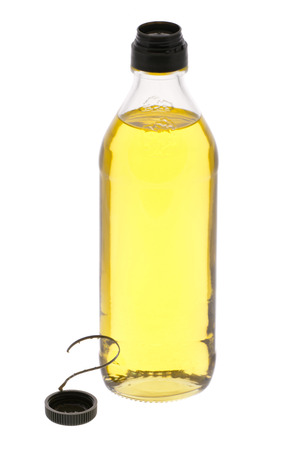 Large bottle of olive oil with the lid nearby isolated on whiteの写真素材